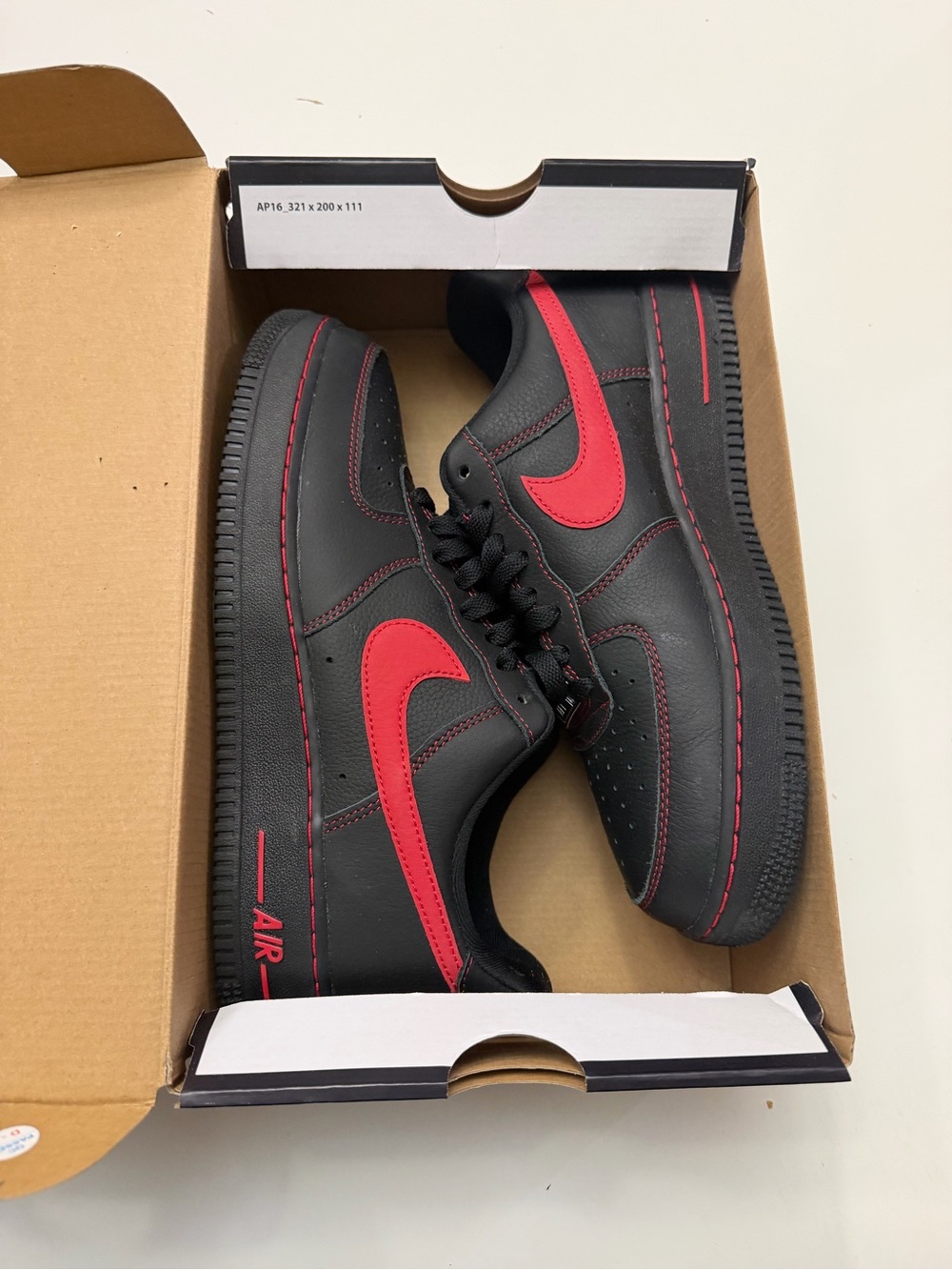 Nike Black Sneakers with Red Swoosh Accent